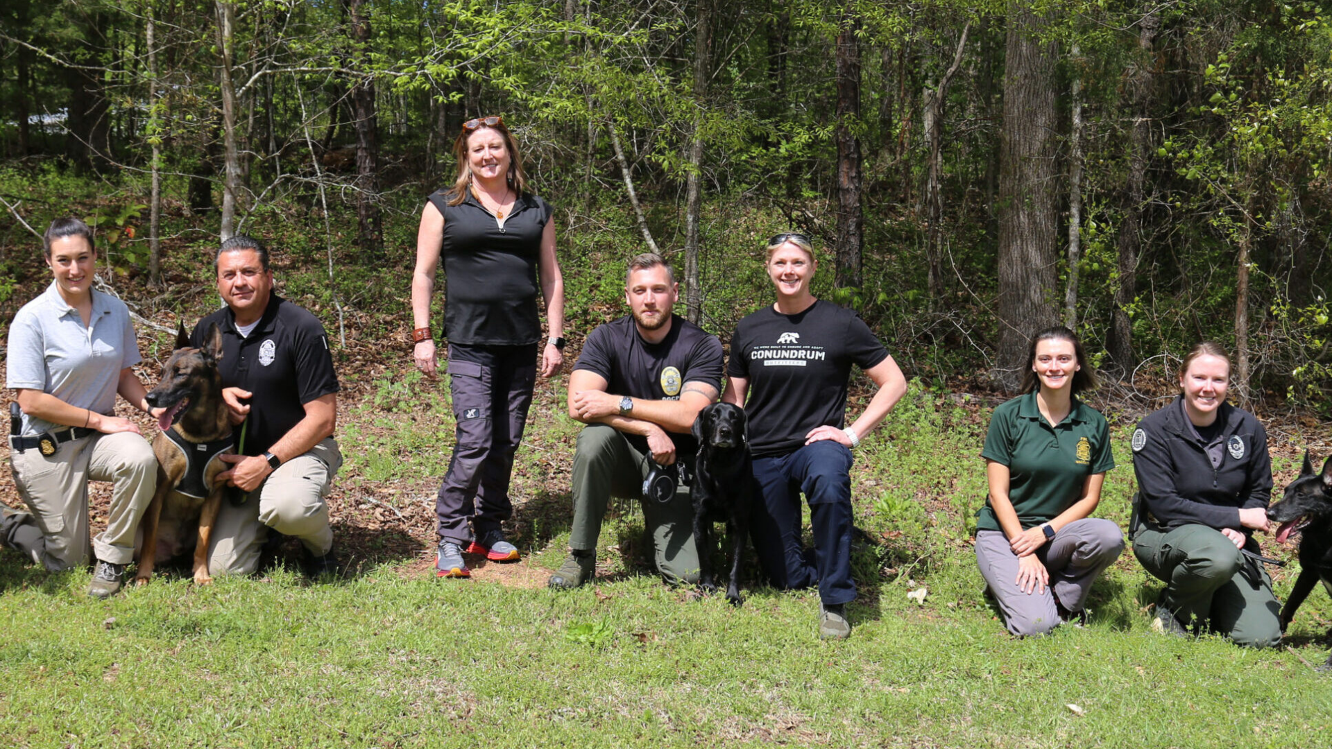 Anna Santos, standing center, with K9 and human officers of the UGA Police Department and Georgia Gwinnett College, along with agents of the Federal Bureau of Investigation who have special training in emergency medical response. This was the initial class of a new training program Santos is developing to help police handlers of K9 officers keep their canine partners healthy. (Amy Carter/CVM)